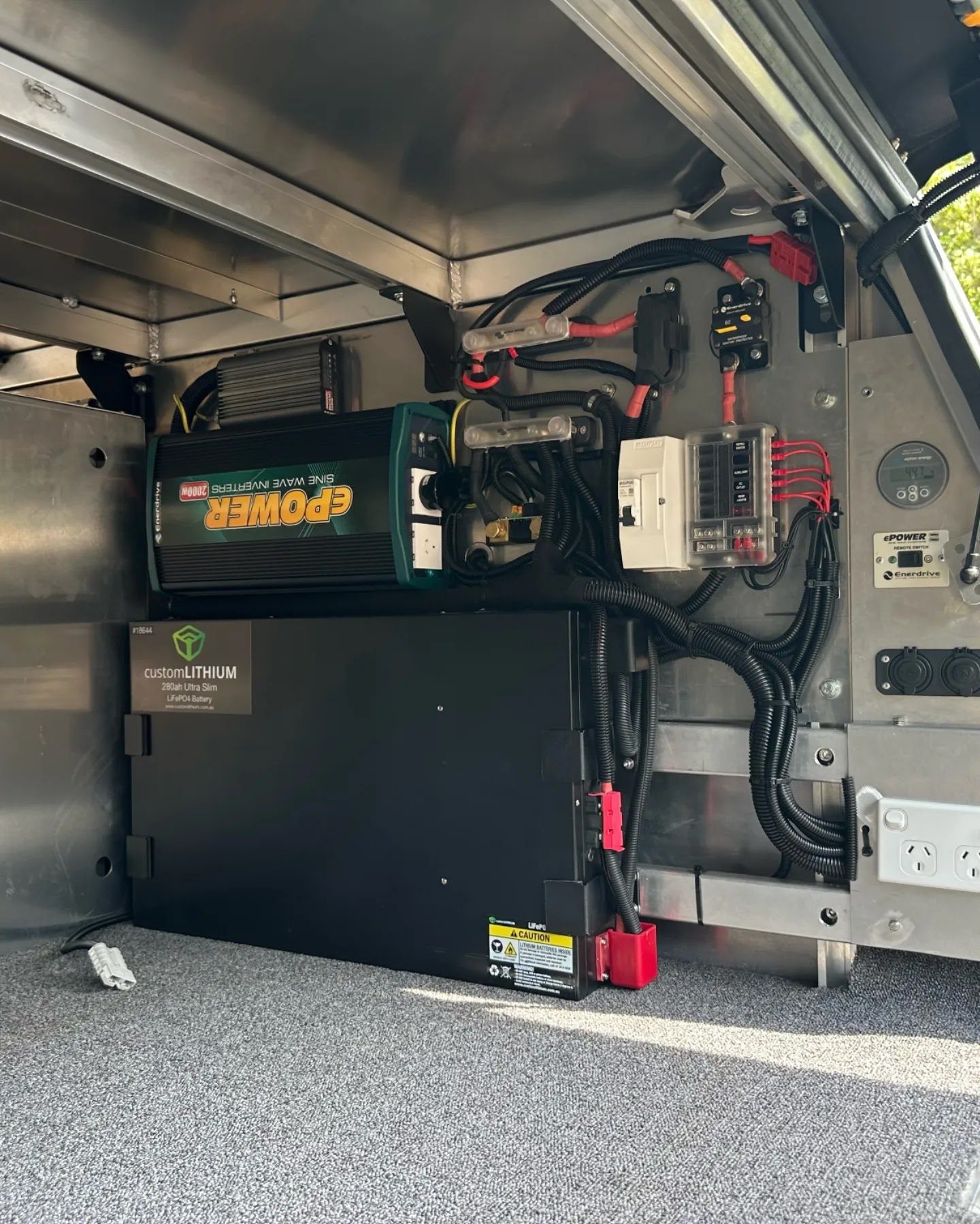 A twelve volt system built into a ute canopy: inverter, lithium battery, fuse block and outlets
