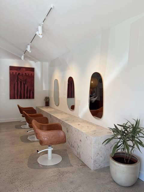 A salon fitout finished by Headland Electrical, with track lighting and backlit arched mirrors